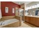 Bathroom with double vanity, soaking tub, and walk-in shower at 2147 Sunbow Ave, Apopka, FL 32703