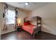 Bedroom with bunk beds and dark hardwood floors at 2147 Sunbow Ave, Apopka, FL 32703