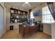 Home office with a large desk, computer monitors, and built-in shelves at 2147 Sunbow Ave, Apopka, FL 32703