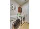 Bright laundry room with washer, dryer, and cabinets at 2147 Sunbow Ave, Apopka, FL 32703