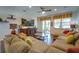 Living room features sectional sofa, hardwood floors, and large TV at 2147 Sunbow Ave, Apopka, FL 32703