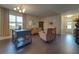 Living room with hardwood floors, contemporary furnishings, and an open floor plan at 2147 Sunbow Ave, Apopka, FL 32703