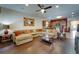 Open concept living room with hardwood floors and kitchen views at 2147 Sunbow Ave, Apopka, FL 32703