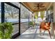 Cozy screened porch with seating and yellow curtains at 2147 Sunbow Ave, Apopka, FL 32703