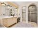 Elegant bathroom features a vanity, large mirror, tiled floors, and a glass-enclosed shower at 236 Acadia Ter, Celebration, FL 34747