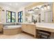 Luxurious bathroom features a soaking tub, stained glass window, vanity area, and tiled floors at 236 Acadia Ter, Celebration, FL 34747