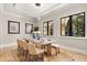 Elegant dining room featuring a large table, neutral decor, and natural light at 236 Acadia Ter, Celebration, FL 34747