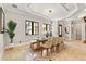 Formal dining room with large windows, a statement light fixture, and a tiled floor at 236 Acadia Ter, Celebration, FL 34747