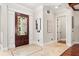 Elegant foyer with decorative wood door, tiled floors, and stylish artwork creating a welcoming entrance at 236 Acadia Ter, Celebration, FL 34747