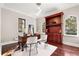 Bright home office features a wooden desk, bookcase, and arched windows at 236 Acadia Ter, Celebration, FL 34747