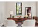 Bright home office features a wooden desk, mirror, and decorative accessories at 236 Acadia Ter, Celebration, FL 34747