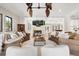 Open-concept living room features wood burning fireplace and neutral decor at 236 Acadia Ter, Celebration, FL 34747