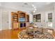 Living room with built-in shelving, hardwood floors, and a fireplace at 236 Acadia Ter, Celebration, FL 34747