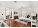 Bright main bedroom with hardwood floors, tray ceilings, and a cozy seating area for relaxing at 236 Acadia Ter, Celebration, FL 34747