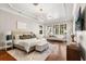 Bright main bedroom with hardwood floors, tray ceilings, and a cozy seating area for relaxing at 236 Acadia Ter, Celebration, FL 34747