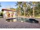 Backyard pool with a cabana area and a brick paved pool deck at 236 Acadia Ter, Celebration, FL 34747