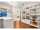 Spacious walk-in closet with custom shelving and hardwood floors at 236 Acadia Ter, Celebration, FL 34747