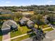 Aerial view of houses and a community with green spaces at 2513 Castle Pines St, Clermont, FL 34711