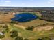 Scenic aerial view of lake and golf course at 2513 Castle Pines St, Clermont, FL 34711