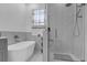 Relaxing bathroom with a freestanding tub and a glass shower enclosure at 2513 Castle Pines St, Clermont, FL 34711