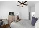 Spacious bedroom with dresser, ceiling fan and views into dining area at 2513 Castle Pines St, Clermont, FL 34711