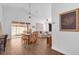Open dining room with a wooden table and access to backyard at 2513 Castle Pines St, Clermont, FL 34711