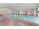 Indoor community pool with brick tile surround at 2513 Castle Pines St, Clermont, FL 34711