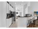 Modern kitchen with white cabinets, granite countertops, and breakfast bar at 2513 Castle Pines St, Clermont, FL 34711