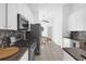 Modern kitchen with white cabinets, granite countertops, and stainless steel appliances at 2513 Castle Pines St, Clermont, FL 34711