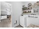 Convenient laundry room with washer, dryer, and shelving at 2513 Castle Pines St, Clermont, FL 34711