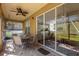 Enjoyable screened porch with table and chairs, and view to backyard at 2513 Castle Pines St, Clermont, FL 34711