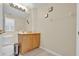 Clean bathroom with wood cabinets and tiled floor at 2627 Oneida Loop, Kissimmee, FL 34747