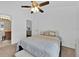 Bright bedroom with a ceiling fan and ensuite bathroom at 2627 Oneida Loop, Kissimmee, FL 34747