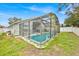 Home exterior showcasing pool and screened enclosure at 2627 Oneida Loop, Kissimmee, FL 34747