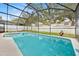 Inviting pool and spa with screened enclosure at 2627 Oneida Loop, Kissimmee, FL 34747
