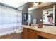 Well-appointed bathroom with wood vanity and striped shower curtain at 2793 Lido Key Dr, Kissimmee, FL 34747