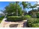 Landscaped walkway with brick pavers, lush greenery, and ornate urns at 2793 Lido Key Dr, Kissimmee, FL 34747