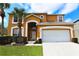 Two-story house with a large garage and palm trees in the front yard at 2793 Lido Key Dr, Kissimmee, FL 34747