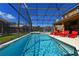 Sparkling pool with a screened patio and plenty of lounge chairs at 2793 Lido Key Dr, Kissimmee, FL 34747