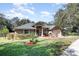 House exterior with a gray roof, double door entry and landscaped yard at 304 Sun Oaks Ct, Lake Mary, FL 32746