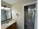 Bathroom with granite vanity, mirror, and access to hallway at 3187 Sea World Ct, Kissimmee, FL 34746