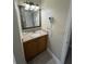 Bathroom vanity with granite countertop and lighted mirror at 3187 Sea World Ct, Kissimmee, FL 34746