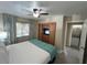 Bright bedroom with a king-size bed, built-in wardrobe, and en-suite bathroom at 3187 Sea World Ct, Kissimmee, FL 34746