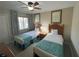 Two twin beds, ceiling fan, and large window in a shared bedroom at 3187 Sea World Ct, Kissimmee, FL 34746