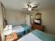 Two twin beds, ceiling fan, and access to a hallway at 3187 Sea World Ct, Kissimmee, FL 34746
