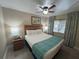 King-size bed, ceiling fan, and nightstand in a well-lit bedroom at 3187 Sea World Ct, Kissimmee, FL 34746