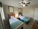 Two twin beds, ceiling fan, and artwork in a cozy bedroom at 3187 Sea World Ct, Kissimmee, FL 34746