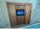 Built-in entertainment center with TV and storage drawers at 3187 Sea World Ct, Kissimmee, FL 34746