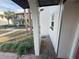 Brick-paved entryway with red door and view of landscaping at 3187 Sea World Ct, Kissimmee, FL 34746