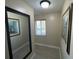 Bright hallway with mirror and framed artwork, featuring wood-look floors at 3187 Sea World Ct, Kissimmee, FL 34746